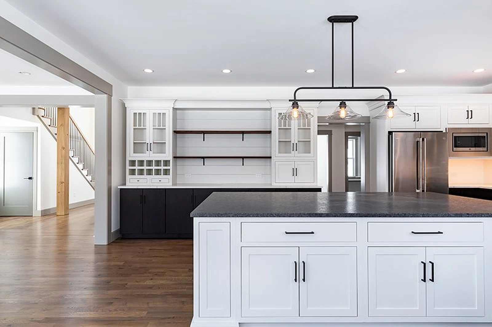 Modern farmhouse kitchen with a white island and contrasting cabinetry